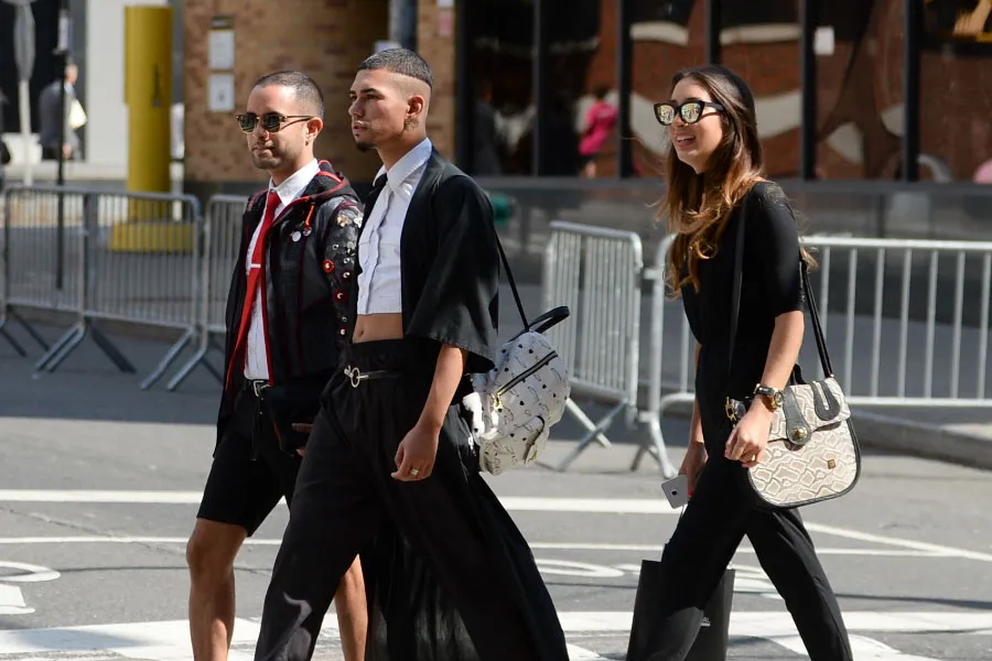 young people with glasses are crossing road